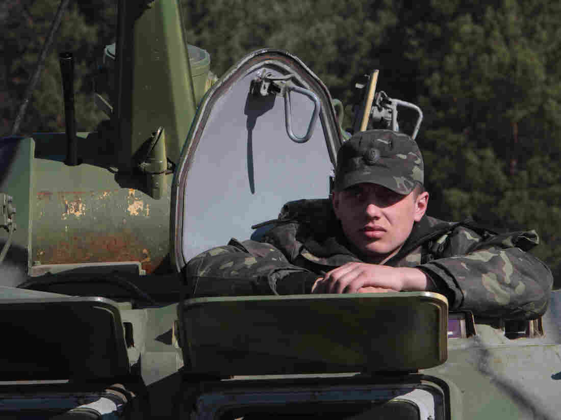 Ukrainian soldier sits in a tank during a military exercise near Goncharovsk village of the Chernigov area in Ukraine on March 14, 2014. Russian troops have gathered near the Ukraine border for exercises as the standoff continues over Crimea.